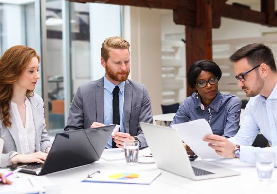 group of co-workers with laptops
